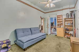Living area featuring carpet floors and a ceiling fan