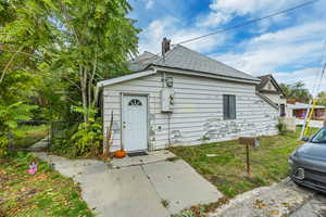 View of front of property with roof with shingles and a gate