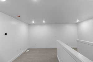 Hall with carpet flooring and recessed lighting