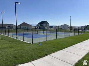 View of tennis court featuring a residential view