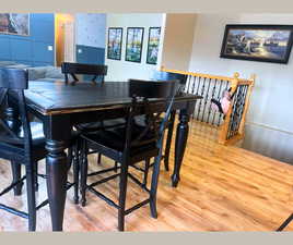 Dining room with light wood-style flooring and wallpapered walls