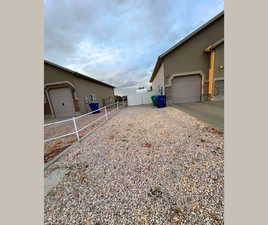 View of home's exterior featuring driveway, a garage, and stucco siding