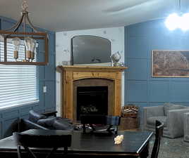 Living area with a decorative wall and a tile fireplace