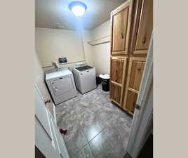 Laundry room with washer and dryer and cabinet space