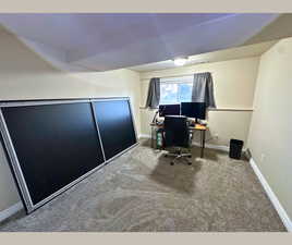 Carpeted office with baseboards