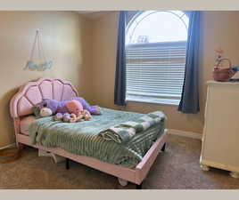 Carpeted bedroom featuring baseboards