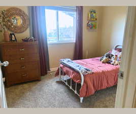 Carpeted bedroom featuring baseboards