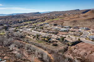 Aerial view of property's location with nearby suburban area and mountains