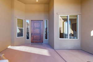 Entrance to property featuring a patio area and stucco siding