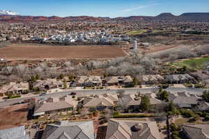 Aerial overview of property's location with nearby suburban area and a mountainous background