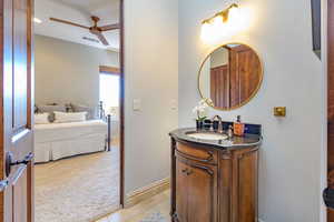 Bathroom featuring vanity, a ceiling fan, light tile patterned flooring, light colored carpet, and ensuite bathroom