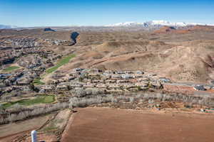 Aerial view of property and surrounding area with nearby suburban area and mountains