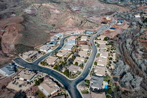 Aerial view of property and surrounding area featuring nearby suburban area