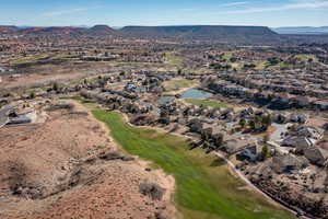 View of property location with a water and mountain view, nearby suburban area, and a golf club
