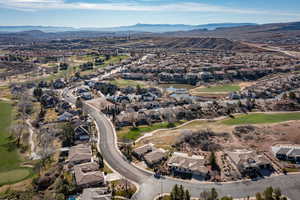 Aerial overview of property's location with nearby suburban area and a water and mountain view