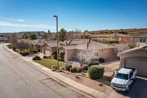 View of front of home with a residential view, a garage, and stucco siding