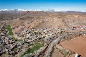 Aerial overview of property's location with a mountainous background and nearby suburban area