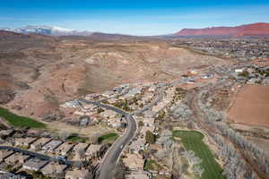 Aerial view of property's location with a mountain backdrop, nearby suburban area, and a local golf course