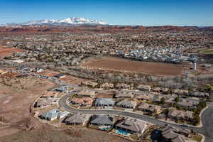 Aerial view of property's location featuring a mountainous background and nearby suburban area