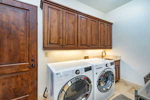 Laundry area featuring cabinet space and washer and clothes dryer