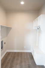 Laundry room with dark wood-style flooring, recessed lighting, and hookup for an electric dryer