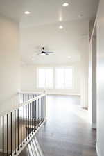 Corridor featuring recessed lighting, light wood-style flooring, and an upstairs landing