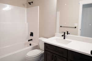 Full bath featuring vanity and shower / tub combination