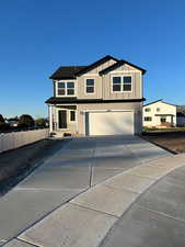View of front of house with driveway and an attached garage