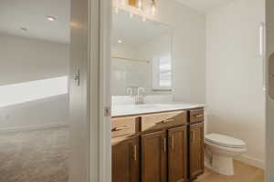 Bathroom featuring vanity, a shower, and recessed lighting