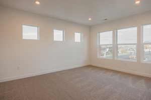 Unfurnished room with light carpet and recessed lighting