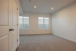 Unfurnished room with light carpet and recessed lighting