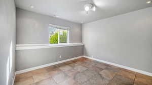 Spare room featuring recessed lighting and light stone finish floors
