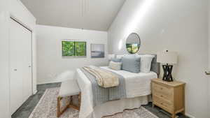Bedroom featuring dark colored carpet, a closet, a ceiling fan, and lofted ceiling