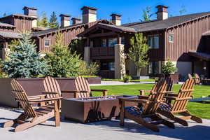 Patio / terrace with a fire pit, a patio area, and a lawn