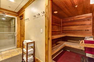 Relaxing sauna / steam room featuring tile patterned floors