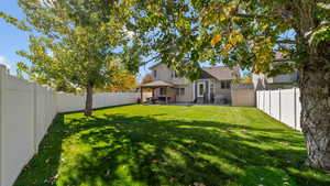 Fenced backyard with a patio area and a gazebo