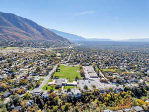 Aerial perspective of suburban area featuring a mountainous background