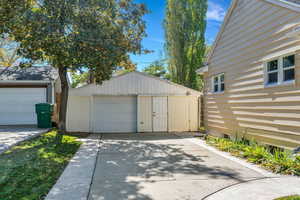 Detached garage featuring concrete driveway