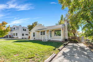 Bungalow featuring covered porch and a chimney