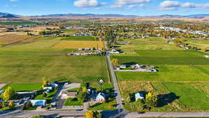 Aerial view of sparsely populated area featuring mountains and extensive farmland