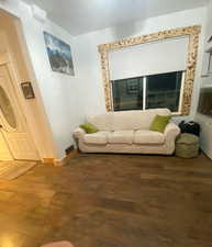 Living room featuring wood finished floors and baseboards