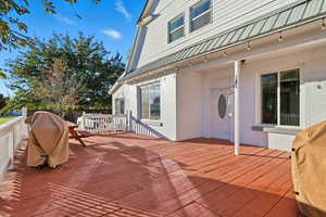Wooden deck featuring grilling area and front entrance