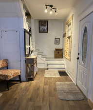 Foyer entrance with dark wood-type flooring and stairs