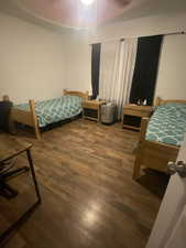 Bedroom featuring dark wood-style floors and ceiling fan