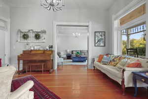 Living area featuring a chandelier and wood finished floors