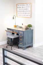 Bar area with light countertops, light wood-type flooring, and blue cabinets
