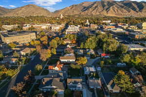 Aerial view of property and surrounding area featuring a mountainous background