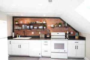 Bar with open shelves, white appliances, white cabinetry, dark countertops, and tasteful backsplash