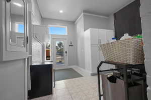 Kitchen featuring white cabinetry and baseboards