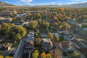 Aerial view of property's location featuring a mountainous background and nearby suburban area
